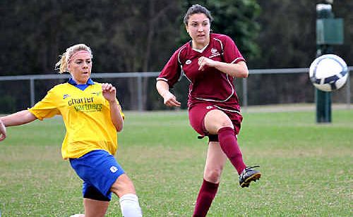 Gympie Miner Christie Bryant defends as a QAS attacker shoots for goal. Gympie Miner Christie Bryant defends as a QAS attacker shoots for goal.
